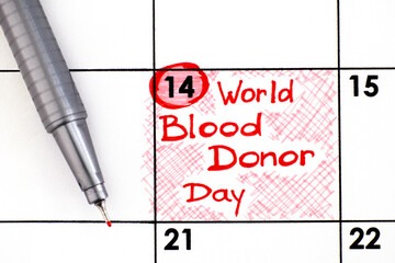 Reminder World Blood Donor Day in calendar with pen