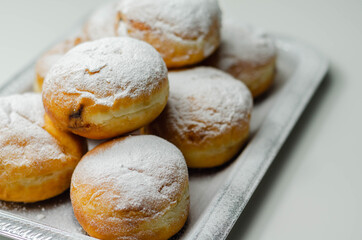 Berliner Pfannkuchen, a German donut, traditional yeast dough deep fried filled with chocolate cream and sprinkled with powdered sugar