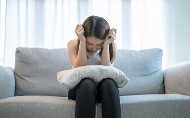 Asian woman is introverted alone in her bedroom, She is lonely and has stress, Depression.