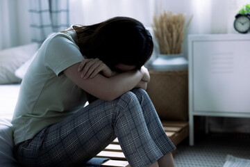 Asian woman is introverted alone in her bedroom, She is lonely and has stress, Depression.