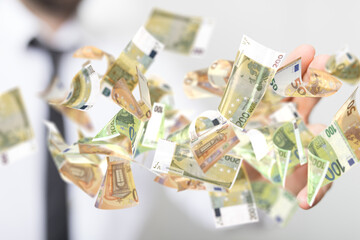 euro bills flying around  in hand