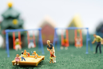 Fototapeta premium Miniature people : Children are enjoy playing together at the playground with many plaything use as children day concept.