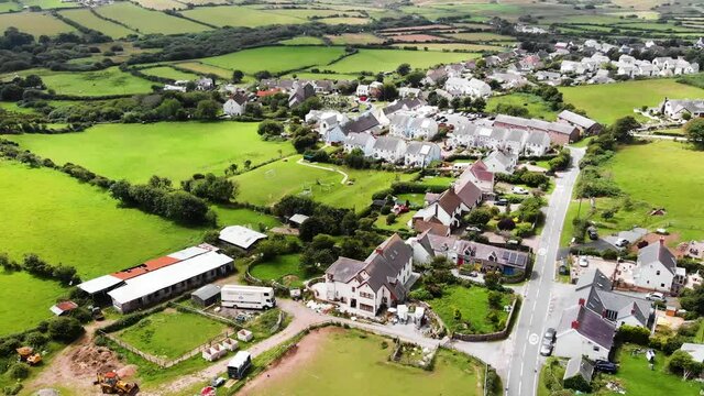 Slow Panning Upwards Shot Of Llangennith Village, With Rhossili Beach and Rhossili Bay In The Background, In The Gower Peninsula, Llangennith, Wales