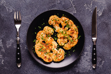 Cauliflower steak with spices cooked in the oven, top view.