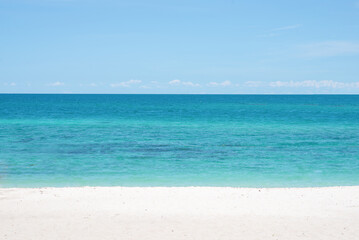 Fototapeta na wymiar Beautiful wide of seascape with blue sky at daylight. Sand of beach smooth Sea.
