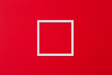 White frame in the form of a square on a red background. Flat lay, copy space