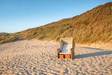 Empty roofed wicker beach chair, North Sea coast, Germany