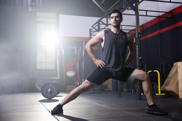 Fototapeta na wymiar A Man Stretching His Legs Before Workout