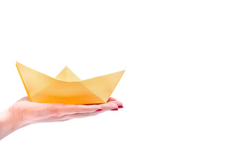 Paper boat. Hands hold a boat made of paper. Isolate. Copy space.