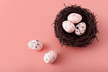 Easter nest with quail eggs on colorful background