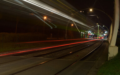 Fototapeta na wymiar Tram at night and blurred traffic, tram stop