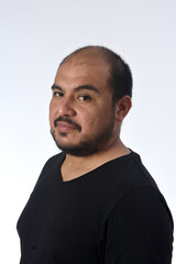 Fototapeta premium portrait of a latin man serious and looking at camera on white background