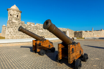 Fototapeta na wymiar Old Spanish guns turrets of Fort of Saint Charles, or Fortaleza de San Carlos de la Cabana, facing the old fort.