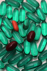 green/brown/red pills on white background