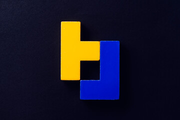 Blue and yellow tetris puzzles on a dark background.