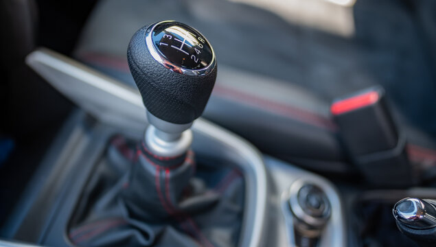 Intertior of a Suzuki motor vehicle focusing on the gear stick with untentional shallow depth of field and bokeh