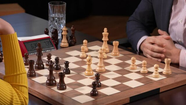 Man and woman at final part of chess game. Static shot and close up