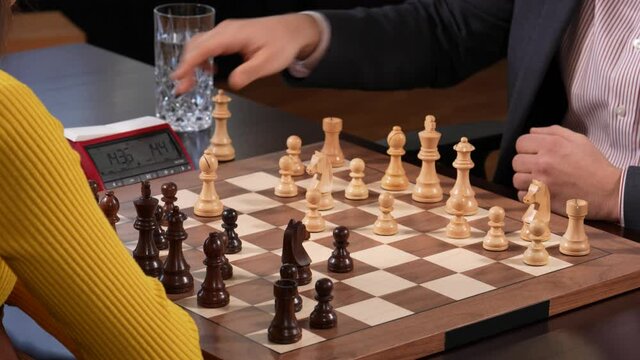 Chess game opening with bishop attack in mixed match. Close-up static shot