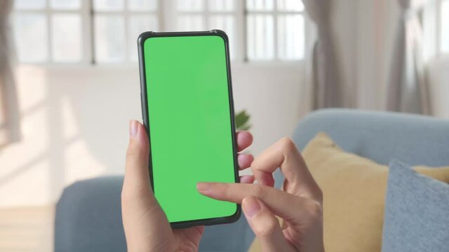Hand Female Using Smartphone With Green Screen In Living Room 
