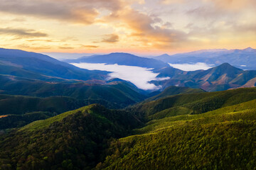 Fototapeta premium Majestic fog in the mountains landscape. Beautiful white misty landscape mountain at Ban Huai Thon in the region of Nan , Thailand.