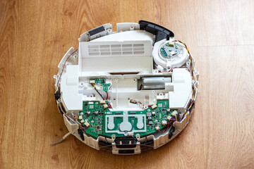 Repair of the robot vacuum cleaner. Disassembled robot vacuum cleaner close-up
