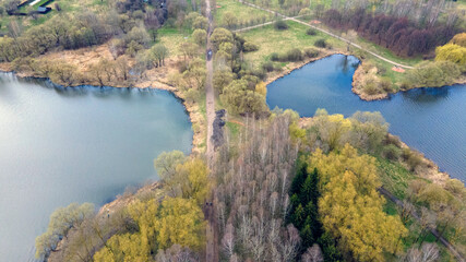 Fototapeta na wymiar Aerial photography of the spring city park. The shore of the reservoir.
