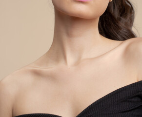 Women neck and shoulders on nude background