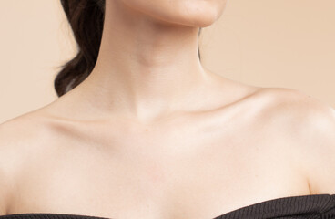 Fototapeta na wymiar Women neck and shoulders on nude background
