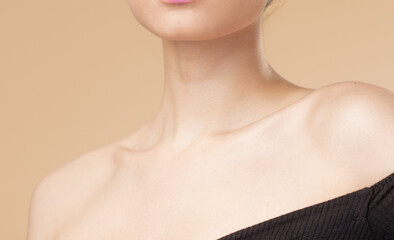 Women neck and shoulders on nude background
