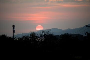 the sun setting behind mountains