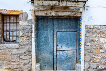 Picturesque wooden door, quite worn and ornate.