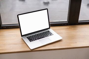 Blank screen laptop. Home office workspace. Modern nordic interior design template.