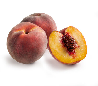 Peaches in Group of Three &ndash; Bunch of Glossy-Skinned, Smooth, Cut Open, Halved Red and Yellow Peach &ndash; Detailed Close-Up Macro on Red Stone &ndash; Isolated on White Background