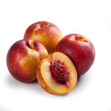 Nectarines in Group of Four &ndash; Bunch of Glossy-Skinned, Smooth, Cut Open, Halved Peach Variety, Red and Yellow &ndash; Detailed Close-Up Macro on Red Stone &ndash; Isolated on White Background