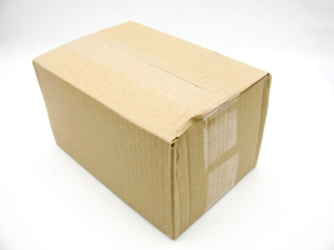 a brown corrugated cardboard box covered with duct tape on a white background