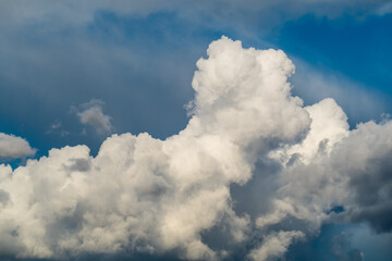 Naklejka na ściany i meble Bizarre cumulus clouds in blue sky