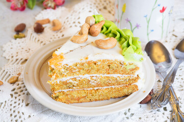 Slice of homemade carrot cake with cream cheese frosting on white plate.