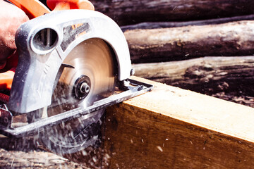 Milling wood in the joinery using manual mechanical cutters. Hands of a man who is sawing a tree...