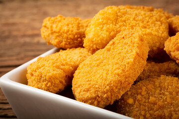 Fried chicken nuggets with ketchp and rose sauce.