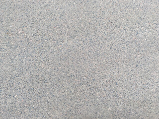 Gray new solid road asphalt with small stones. The background. Texture