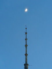 The spire of tv tower and mood at the blue clear sky composition