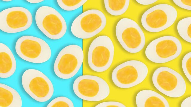 Video 4k pattern of boiled easter eggs cut in half moves in blue on yellow background