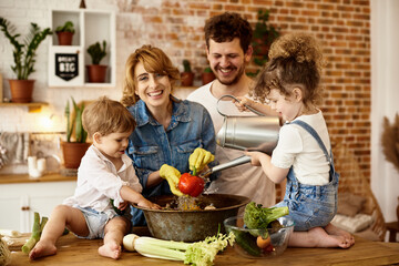 happy family with their children cooking in the kitchen