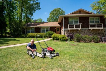 Man taking rest from cutting grass in summer