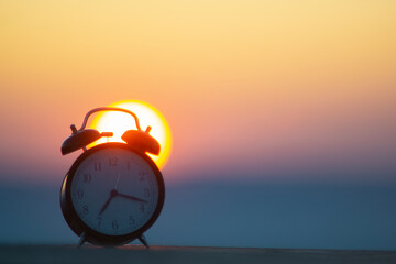ALARM CLOCK ON SUNRISE MORNING WITH LIGHT FLARES