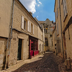 Fototapeta na wymiar Cosy cobblestone street with old houses in Senlis, France