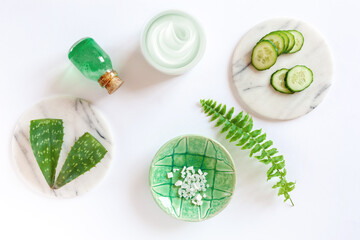 SPA beauty concept fresh aloe and cucumber products - aromatic sea salt, shower gel, skin moisturiser. Concept for spa, beauty and health salon, cosmetics store. Close up photo on white background.