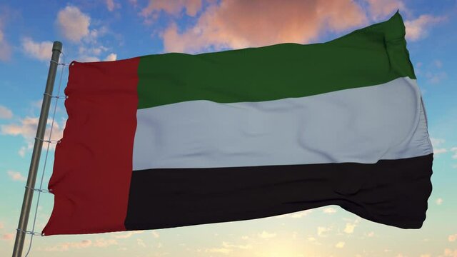Flag of United Arab Emirates waving in the wind against deep beautiful sky at sunset