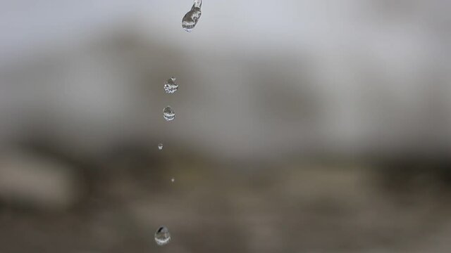 Flowing drops of water are falling.