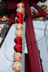 red and pink bulbs for illumination and illumination of the carousel in the evening. vertical photo. Day of the city